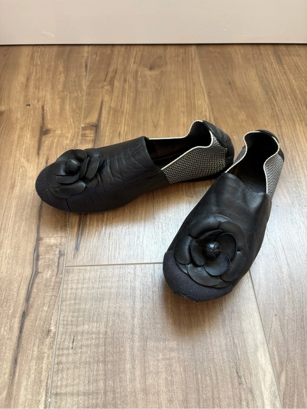 CHANEL Black Leather Camellia Slip-On Flats